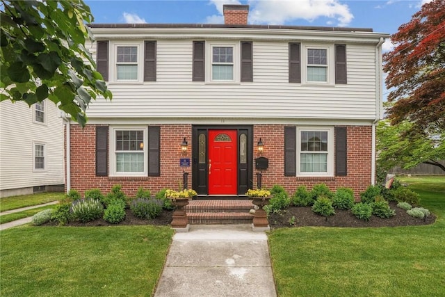11 Elmcroft Ave, Providence, RI 02909 - colonial house featuring a chimney, brick siding, and a front lawn