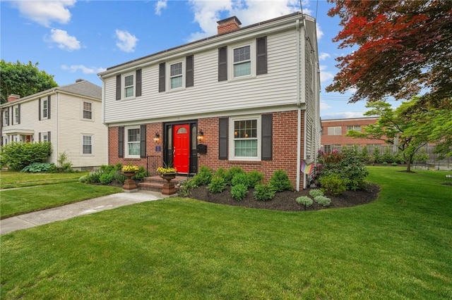 11 Elmcroft Ave, Providence, RI 02909 - colonial inspired home with brick siding, a chimney, and a front lawn