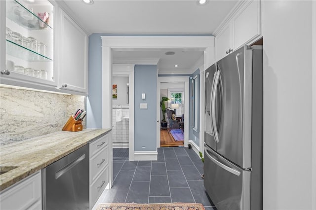 11 Elmcroft Ave, Providence, RI 02909 - kitchen featuring stainless steel appliances, white cabinets, dark tile patterned floors, light stone counters, and ornamental molding
