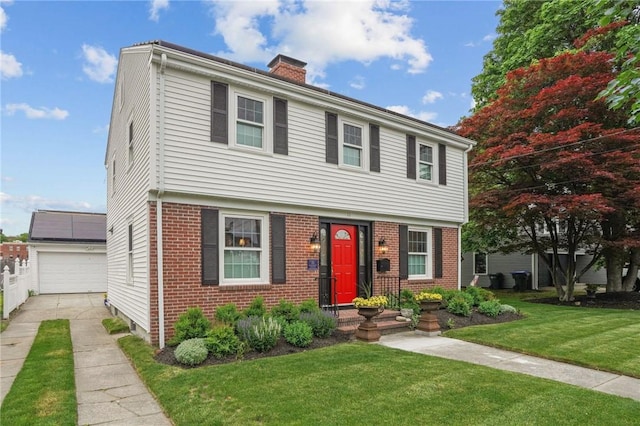 11 Elmcroft Ave, Providence, RI 02909 - colonial house featuring a chimney, brick siding, a front lawn, and an outbuilding