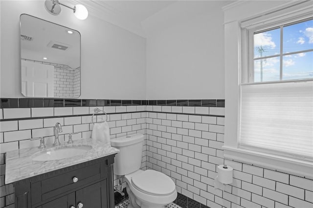 11 Elmcroft Ave, Providence, RI 02909 - bathroom featuring tile walls, toilet, vanity, and a wainscoted wall