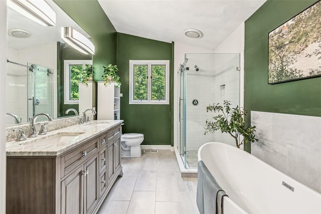 11 Noto Dr, North Providence, RI 02904 - bathroom featuring lofted ceiling, a freestanding bath, a shower stall, double vanity, and toilet