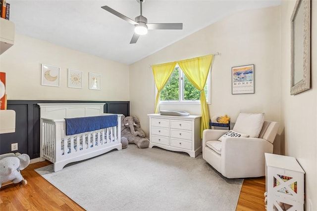 11 Noto Dr, North Providence, RI 02904 - bedroom featuring lofted ceiling, wood finished floors, a nursery area, and ceiling fan