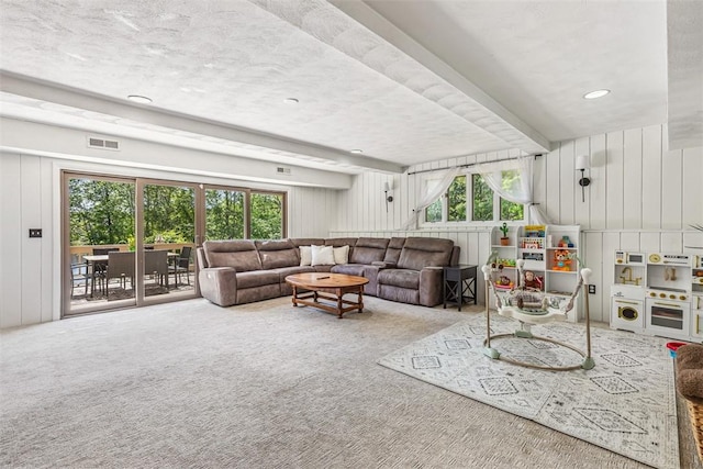 11 Noto Dr, North Providence, RI 02904 - carpeted living area featuring healthy amount of natural light, beam ceiling, and a decorative wall
