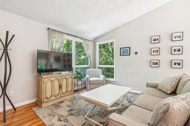 11 Noto Dr, North Providence, RI 02904 - living room with vaulted ceiling, baseboards, and light wood-style flooring