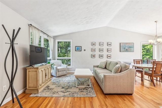 11 Noto Dr, North Providence, RI 02904 - living room featuring a chandelier, lofted ceiling, light wood-style floors, and baseboards