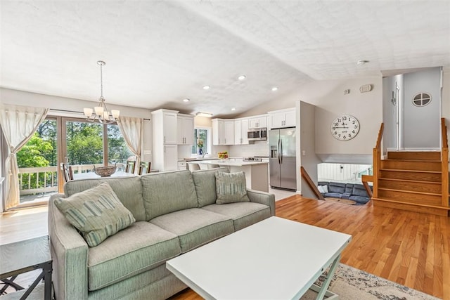 11 Noto Dr, North Providence, RI 02904 - living area with light wood-style floors, recessed lighting, vaulted ceiling, a chandelier, and stairway