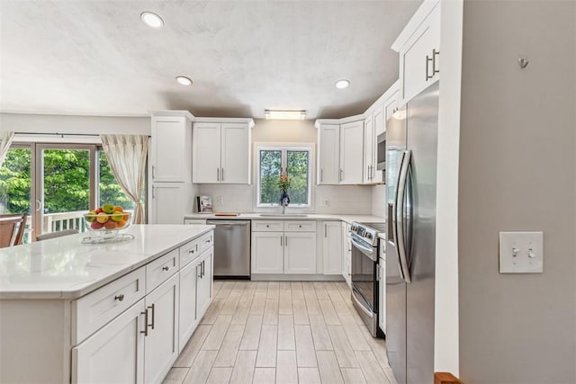 11 Noto Dr, North Providence, RI 02904 - kitchen featuring stainless steel appliances, a sink, white cabinets, a kitchen island, and recessed lighting