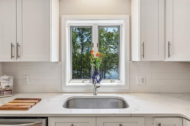 11 Noto Dr, North Providence, RI 02904 - kitchen featuring stainless steel dishwasher, a sink, white cabinetry, and tasteful backsplash