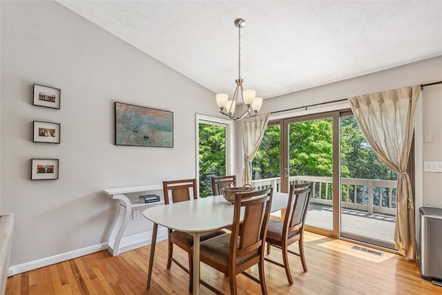 11 Noto Dr, North Providence, RI 02904 - dining area featuring light wood-style floors, a chandelier, baseboards, and lofted ceiling