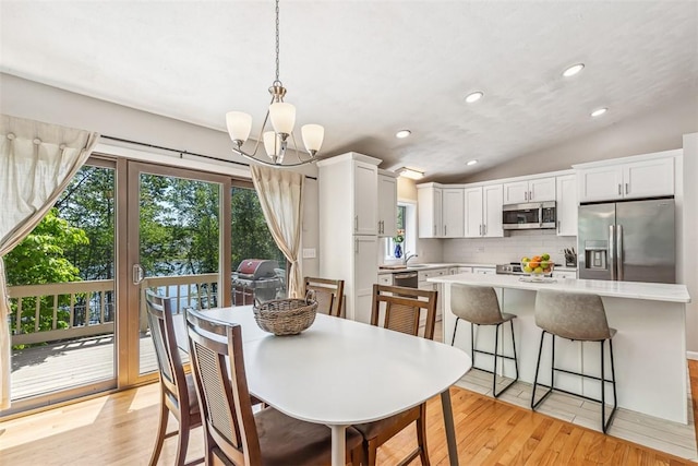 11 Noto Dr, North Providence, RI 02904 - dining room featuring a chandelier, light wood-style floors, vaulted ceiling, and recessed lighting