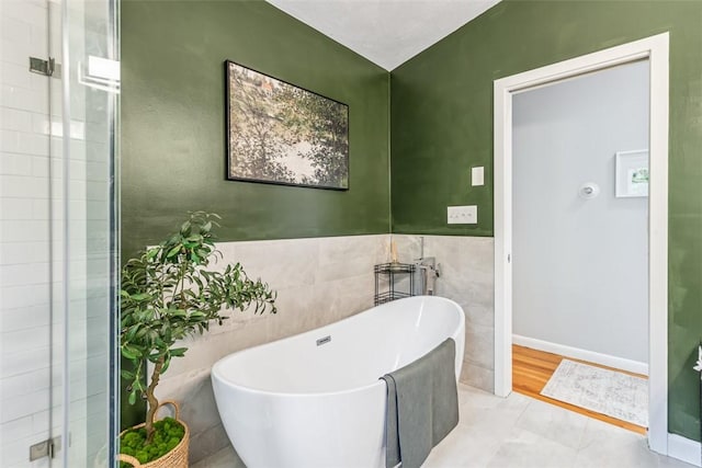 11 Noto Dr, North Providence, RI 02904 - bathroom with a freestanding tub, tile walls, and a shower stall