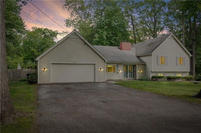 8 Westgate Rd, Cumberland, RI 02864 - tri-level home featuring a chimney, driveway, and an attached garage