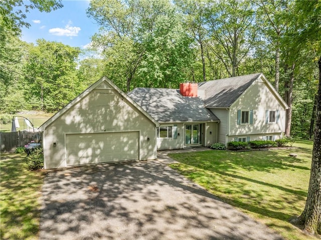 8 Westgate Rd, Cumberland, RI 02864 - split level home featuring asphalt driveway, an attached garage, and a chimney