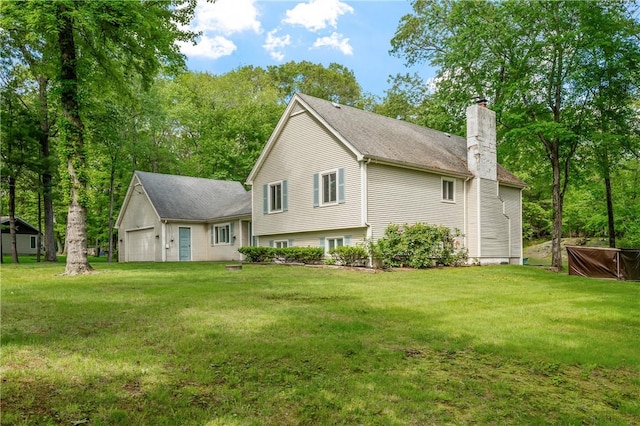 8 Westgate Rd, Cumberland, RI 02864 - back of property featuring a chimney, a yard, and an attached garage