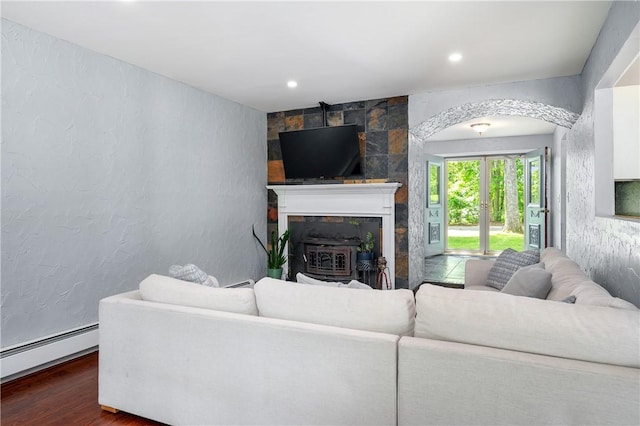 8 Westgate Rd, Cumberland, RI 02864 - living room featuring wood finished floors, a baseboard heating unit, a textured wall, arched walkways, and recessed lighting