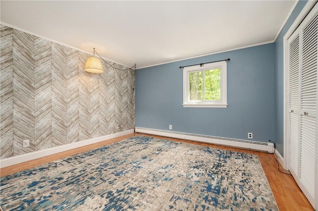 8 Westgate Rd, Cumberland, RI 02864 - spare room with a baseboard heating unit, wood finished floors, ornamental molding, and baseboards