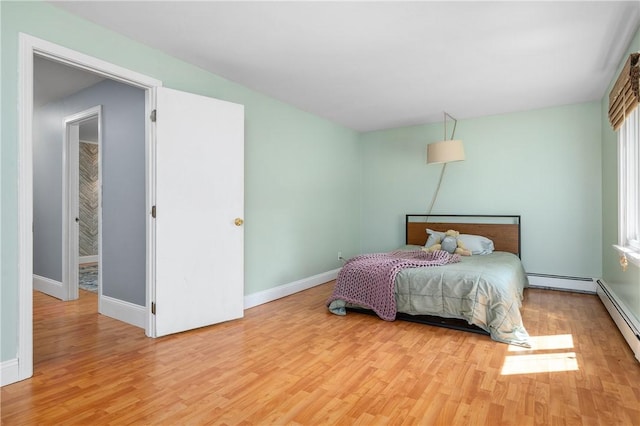 8 Westgate Rd, Cumberland, RI 02864 - bedroom featuring wood finished floors, baseboards, and a baseboard radiator