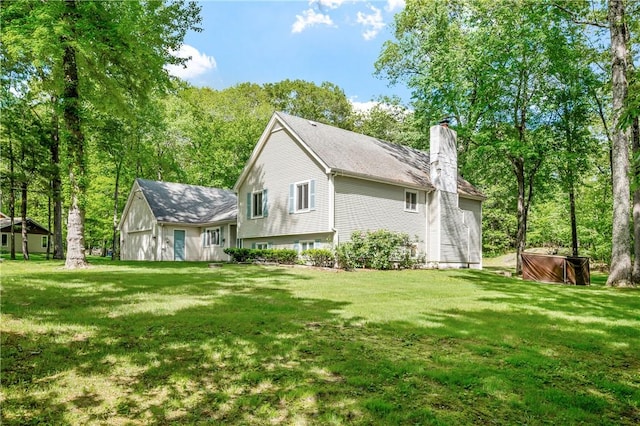 8 Westgate Rd, Cumberland, RI 02864 - rear view of property with a chimney, a hot tub, and a lawn