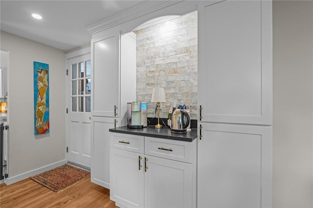25 King Philip Rd, Pawtucket, RI 02861 - bar featuring light wood-style flooring, decorative backsplash, recessed lighting, and baseboards