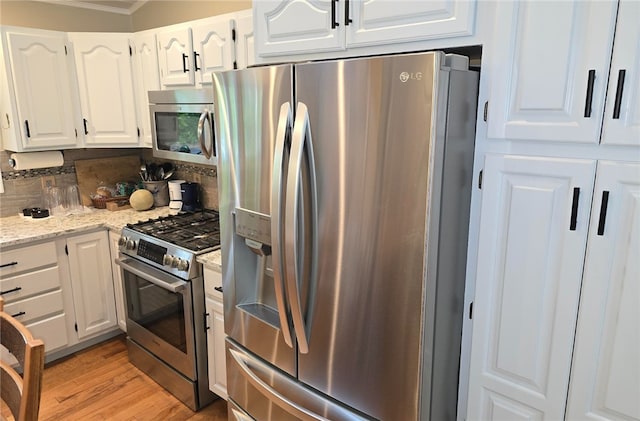 190 Broad Rock Rd, South Kingstown, RI 02879 - kitchen with stainless steel appliances, white cabinetry, crown molding, light wood finished floors, and light stone countertops