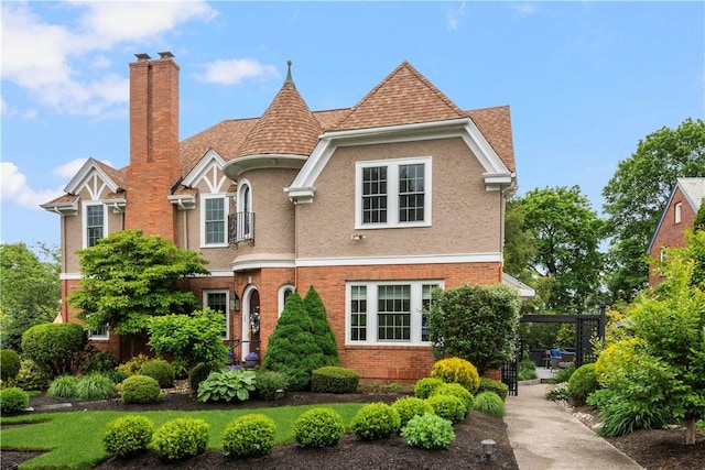 34 Dryden Ave, Pawtucket, RI 02860 - view of front of home with a chimney, stucco siding, and brick siding