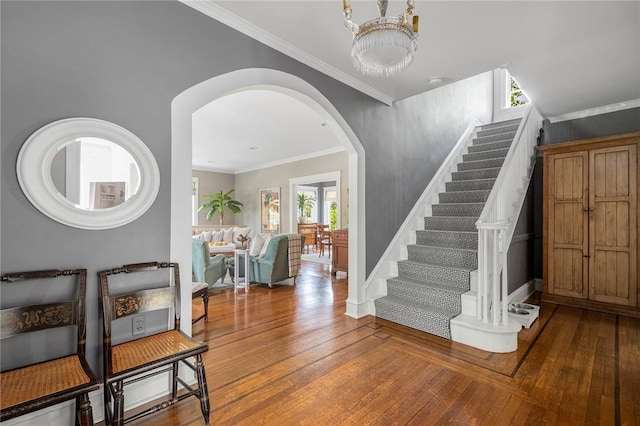 34 Dryden Ave, Pawtucket, RI 02860 - entrance foyer featuring arched walkways, stairway, hardwood / wood-style flooring, a chandelier, and crown molding