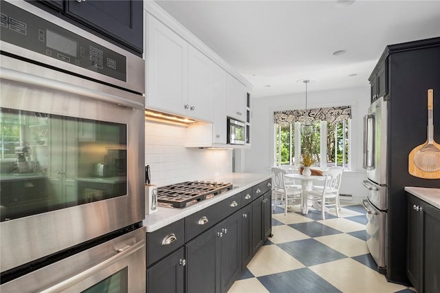 34 Dryden Ave, Pawtucket, RI 02860 - kitchen with light floors, light countertops, stainless steel appliances, backsplash, and white cabinets