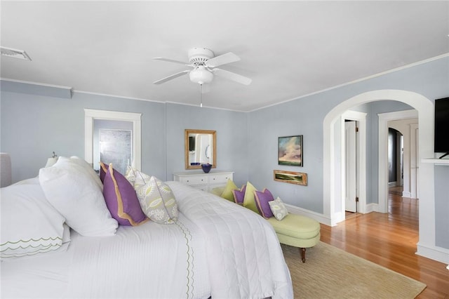 34 Dryden Ave, Pawtucket, RI 02860 - bedroom with wood finished floors, arched walkways, baseboards, crown molding, and ceiling fan