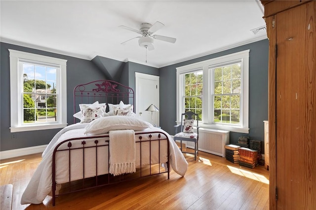 34 Dryden Ave, Pawtucket, RI 02860 - bedroom with radiator heating unit, multiple windows, light wood finished floors, ornamental molding, and baseboards