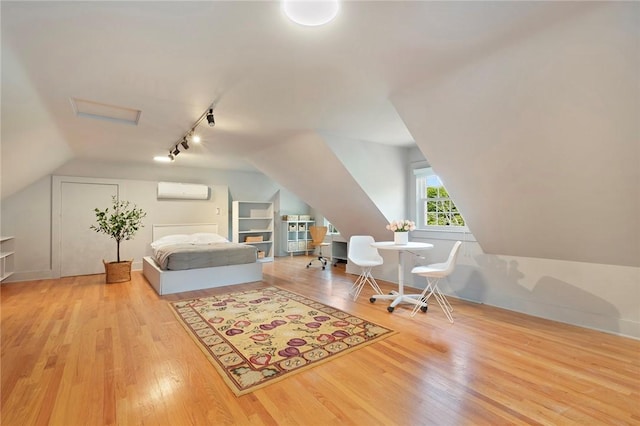 34 Dryden Ave, Pawtucket, RI 02860 - bedroom with track lighting, lofted ceiling, wood finished floors, a wall mounted air conditioner, and attic access