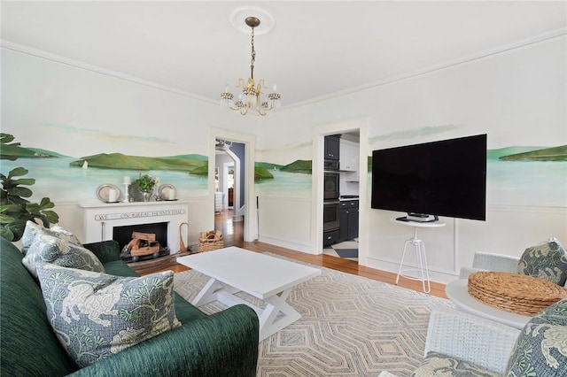 34 Dryden Ave, Pawtucket, RI 02860 - living area with a chandelier, wood finished floors, crown molding, and a fireplace