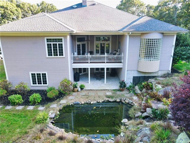 51 W Ridge Dr, Tiverton, RI 02878 - back of property with a patio, roof with shingles, ceiling fan, and a chimney
