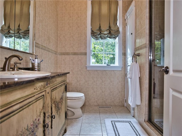51 W Ridge Dr, Tiverton, RI 02878 - bathroom with tile walls, vanity, a stall shower, toilet, and tile patterned floors