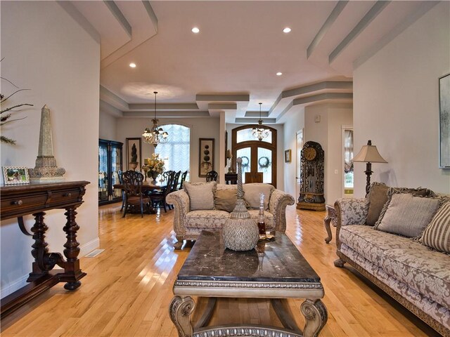 51 W Ridge Dr, Tiverton, RI 02878 - living area featuring a chandelier, french doors, a tray ceiling, light wood-style floors, and recessed lighting