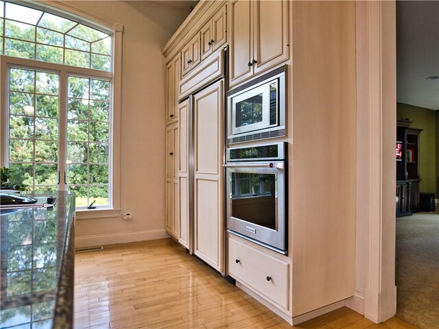 51 W Ridge Dr, Tiverton, RI 02878 - kitchen featuring stainless steel appliances, light wood-style flooring, baseboards, and cream cabinetry
