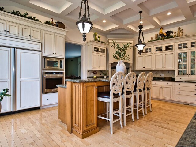 51 W Ridge Dr, Tiverton, RI 02878 - kitchen with built in appliances, tasteful backsplash, light wood finished floors, beam ceiling, and coffered ceiling