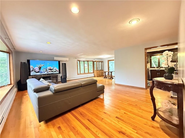 3945 Post Rd, Warwick, RI 02886 - living room with a wall mounted AC, a baseboard radiator, light wood-style flooring, recessed lighting, and baseboards