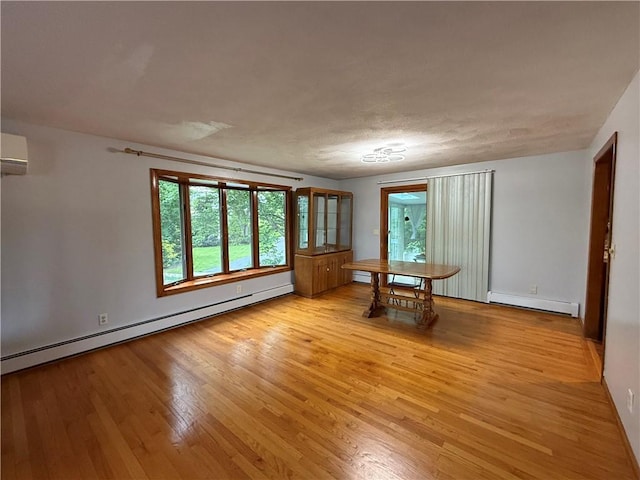 3945 Post Rd, Warwick, RI 02886 - unfurnished dining area with baseboard heating, light wood-type flooring, and healthy amount of natural light