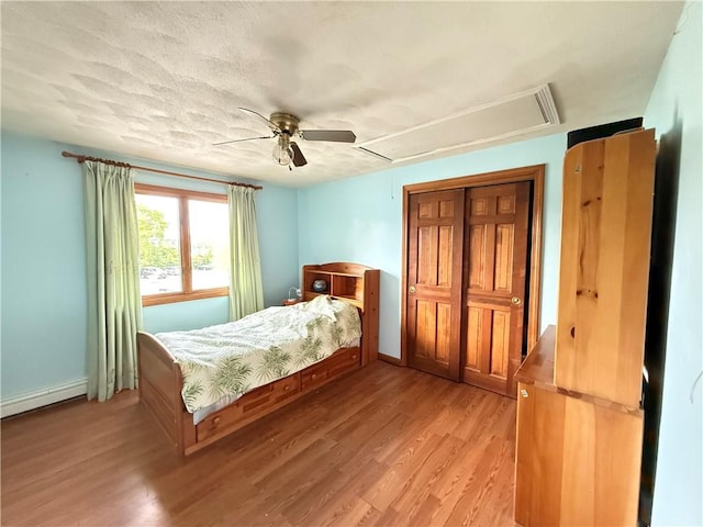 3945 Post Rd, Warwick, RI 02886 - bedroom with attic access, a baseboard radiator, light wood-style floors, and baseboards