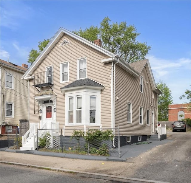 15 Ruggles St, Providence, RI 02908 - traditional-style house featuring a chimney and a fenced front yard