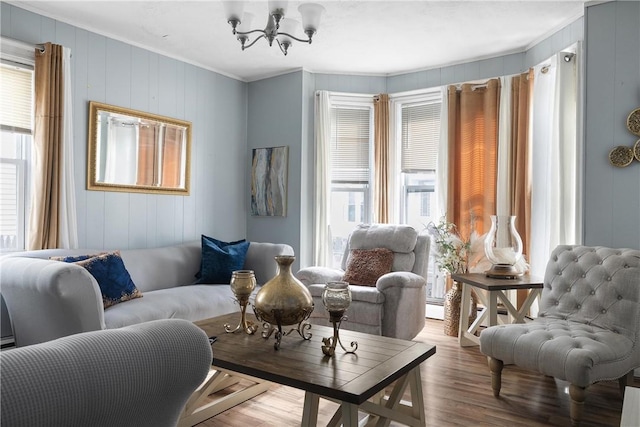 15 Ruggles St, Providence, RI 02908 - living area with ornamental molding, healthy amount of natural light, a chandelier, wood finished floors, and a decorative wall