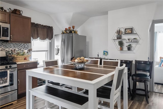 15 Ruggles St, Providence, RI 02908 - kitchen with stainless steel appliances, dark brown cabinetry, wood finished floors, backsplash, and lofted ceiling