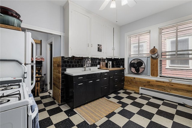 43 Chapin Ave Unit 3, Providence, RI 02909 - kitchen featuring light flooring, dark cabinetry, a baseboard radiator, white cabinets, and light countertops