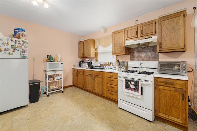 22 Myrtle St, Pawtucket, RI 02860 - kitchen featuring white appliances, under cabinet range hood, light countertops, decorative backsplash, and brown cabinetry
