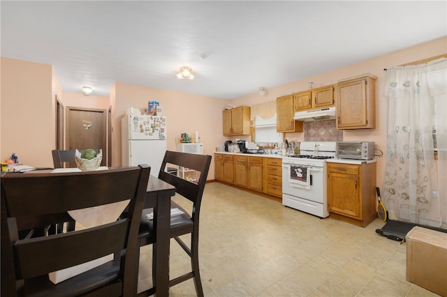 22 Myrtle St, Pawtucket, RI 02860 - kitchen featuring white appliances, under cabinet range hood, light countertops, and tasteful backsplash