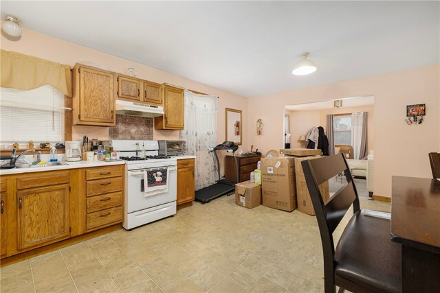 22 Myrtle St, Pawtucket, RI 02860 - kitchen with white gas range, a sink, healthy amount of natural light, and backsplash