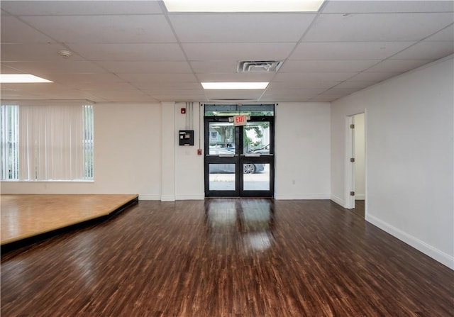 413 High St, Bristol, RI 02809 - empty room with wood finished floors, a smoke detector, a drop ceiling, and french doors