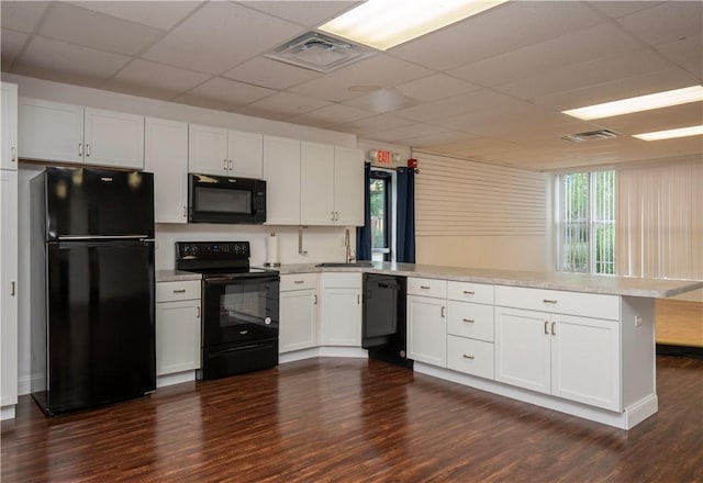 413 High St, Bristol, RI 02809 - kitchen featuring black appliances, a peninsula, dark wood finished floors, light countertops, and a paneled ceiling