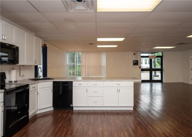 413 High St, Bristol, RI 02809 - kitchen with black appliances, plenty of natural light, white cabinetry, light countertops, and a drop ceiling